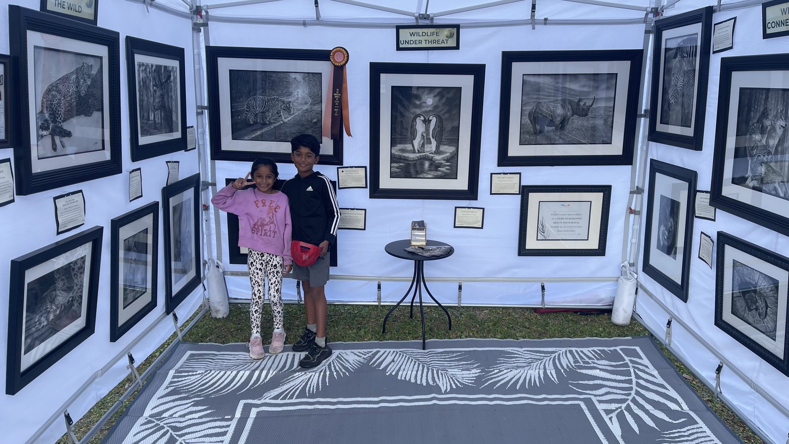 Wide view of the artist's festival booth display